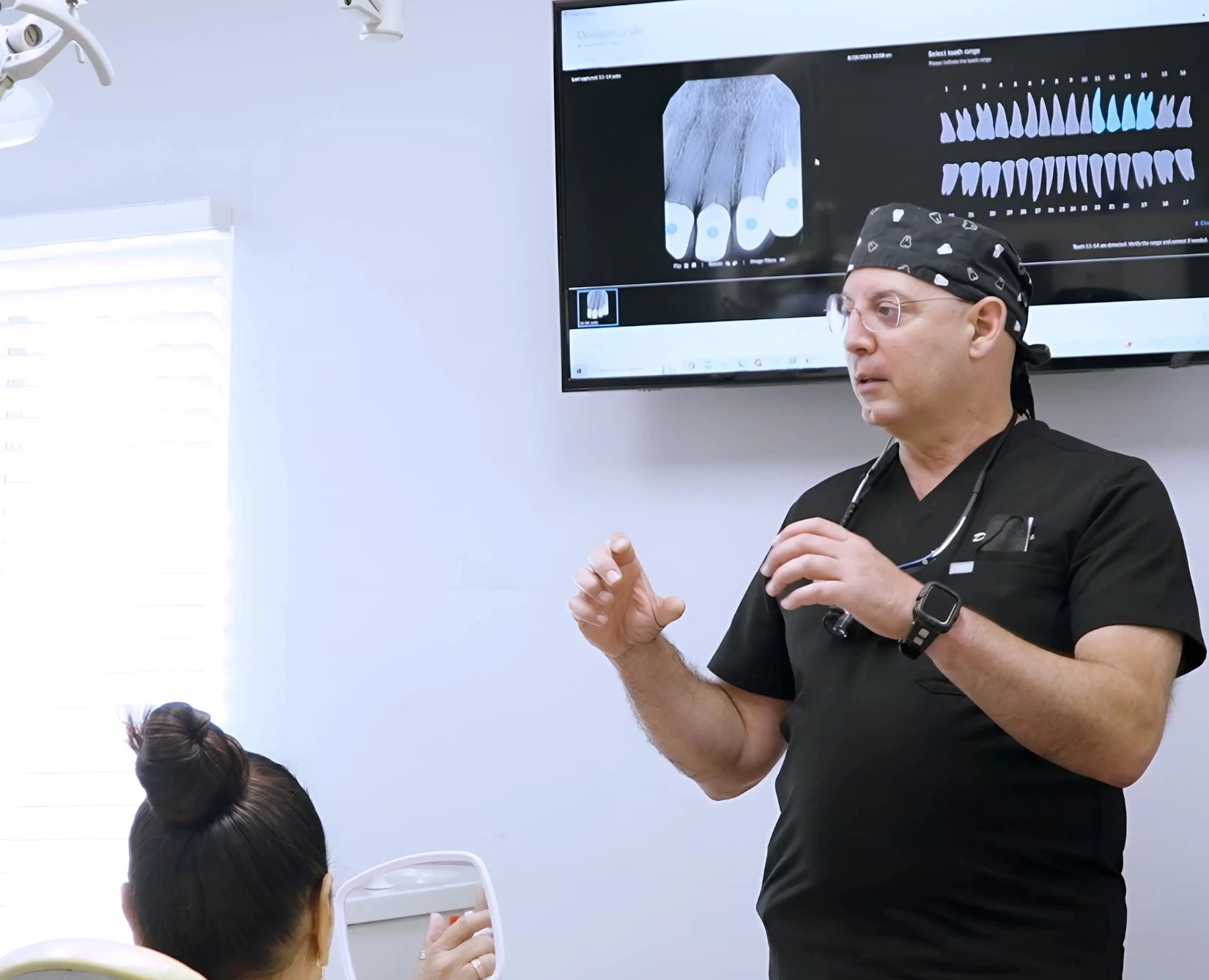 A Gardena Dental Group dentist explaining a digital X-ray to a patient chairside